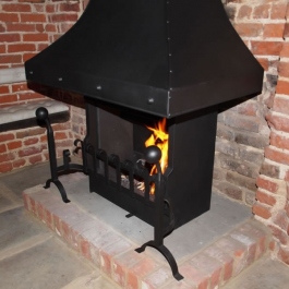 Anniversary Edition Thermovent high performance open fire with hand forged dog irons and grate front installed in this large Inglenook open fireplace.