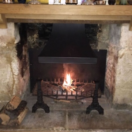 Hand made steel canopy in a wood burning open fire place with clients original fire grate.