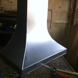 A finished steel canopy for a woodburning open fire ready to be hand scored and polished