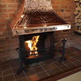 Inglenook open fireplace with large copper canopied Thermovent conecting open fire. Fluer des Lis dog irons with bow front grate.