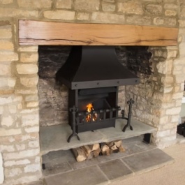 New oak beam installed in this Cotswold stone open fireplace when it was opened up.