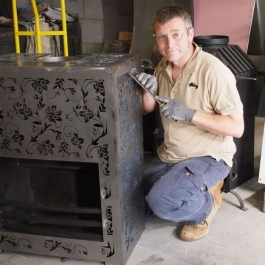 Paul Shaw working on modern open fire with floral pattern in Designfire has Thermovent high performance convecting fire inside