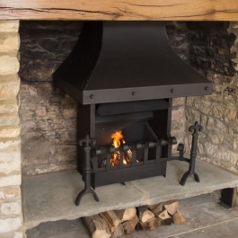 Remodelled open fireplace with raised hearth showing Thermovent convecting open fire with hand cast dog irons and scrool top dog irons.