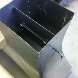 Steel canopy for an original woodburning fire arrangement showing a flue baffle control.