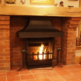 Therovent wood burning convection fire featuring clients own re-worked canopy and dog irons.