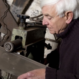 Trevor Shaw, founder of Camelot Real fires, rolling a seam for a canopy at our workshop.