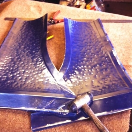 Two sides of a hand beatend copper canopy ready to be worked onto the steel canopy base. not the platic