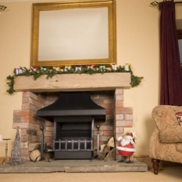 Wood burning thermovent convecting open fire in a medium size fireplace at Christmas time.