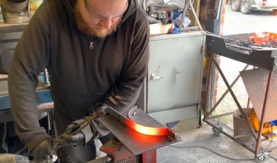 Craftsmen working in the forge with metal