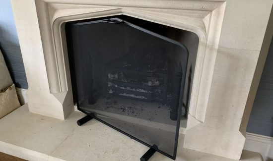 Bespoke fire guard with curved top.