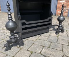 Bespoke fireplace with three bar gate front, and bespoke large dog irons