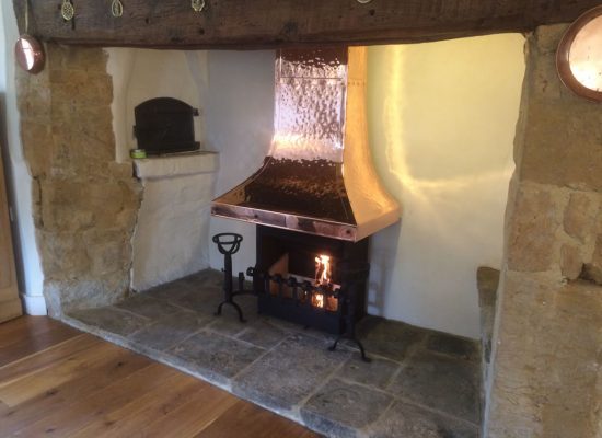 Hand beaten copper inglenook canopy with thermovent.