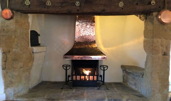 Hand-beaten copper inglenook canopy and thermovent.