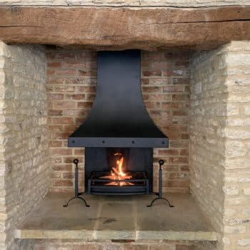 Steel inglenook canopy with three bar bow front fire basket and ball top dog irons.